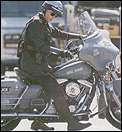 Charlie (Jim Carrey) riding his State Trooper bike
